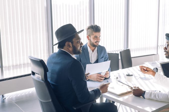 Group of experts analysing during business meeting