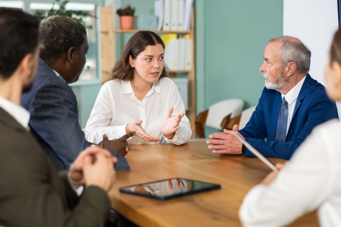 Qualified employees, managers and lawyers at a meeting 