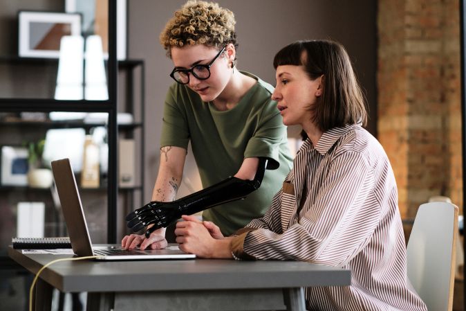 barbri-image-young woman-with-prosthetic-arm-in-office.png