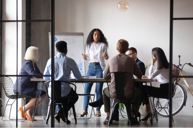 Six young professionals in a conference room having a meeting