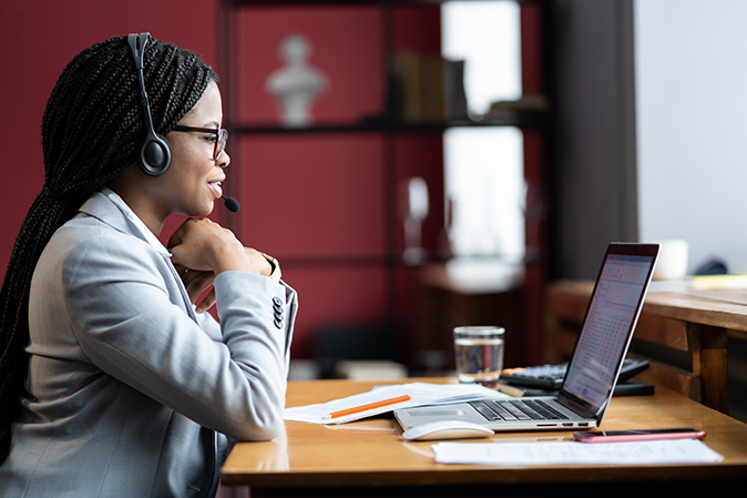 Female attorney at desk with headset on