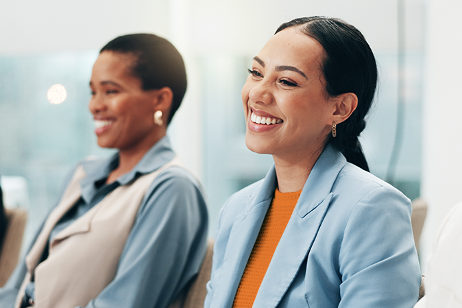Smile, laughing a business woman in a meeting with her colleagues for training in a workshop or seminar. Corporate, conference or education with a happy employee in the boardroom of an office.
