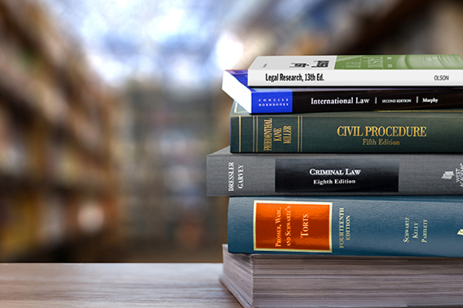 Stack of West Academic Casebooks on a table in a library