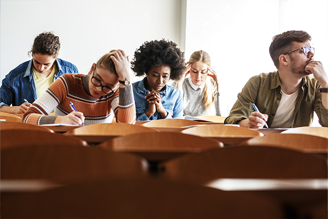 Group of college students working on test in a classroom