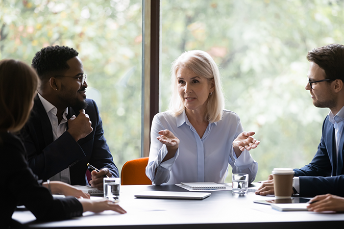 Mature 60s leader ceo company boss give helpful information to young diverse professionals teach them provide knowledge share ideas and strategic plans motivating to fruitful work, mentoring concept