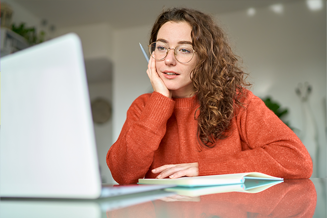 Young woman studying on her laptop