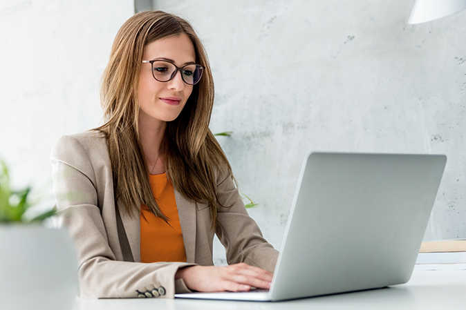 Beautiful Businesswoman typing on laptop