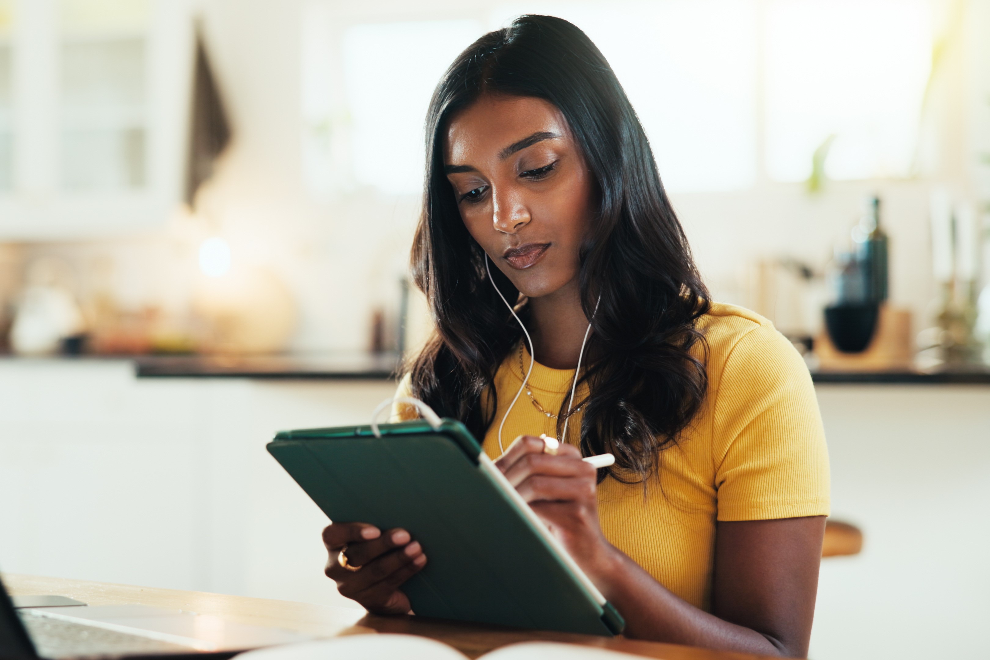 House, student and woman with laptop, tablet and typing with education, internet and prepare for test. Person, apartment and girl with tech, connection and studying for exams and research for project
