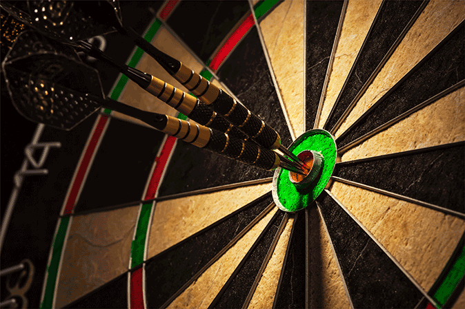Three darts in the bullseye of a target