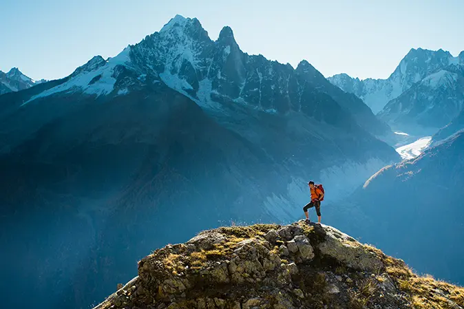 Hiker standing on top of a mountain