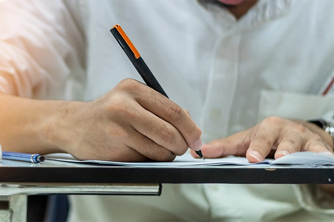 Man taking a test using a pen
