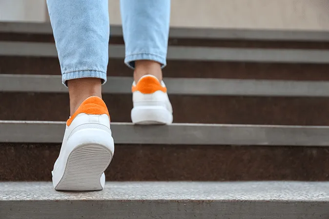 Person walking up steps outside