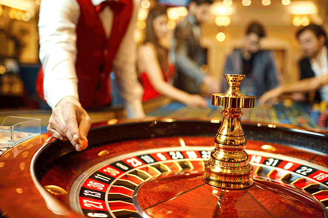 Man dropping a ball on a rouellte wheel at a casino