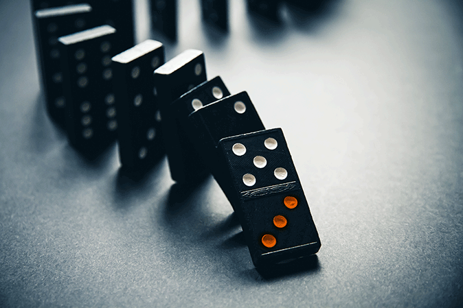 Row of dominoes lined up on a table