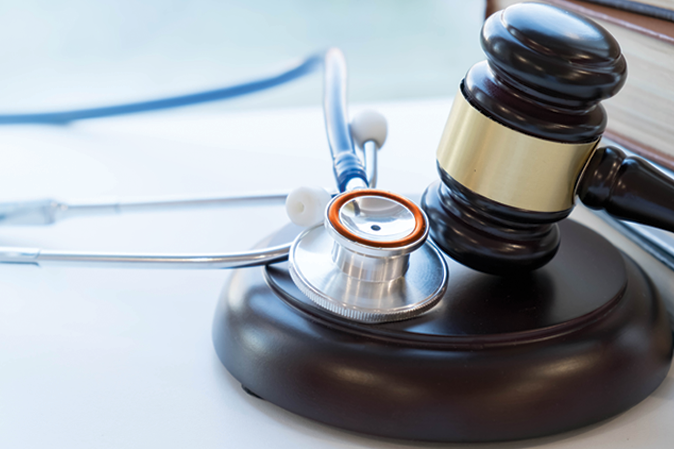 Stethoscope sitting on the base of a judge's gavel
