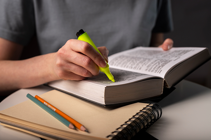 Student underlining sentences in a book