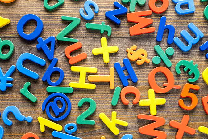 Various colored plastic letters and numbers on a table