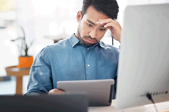 Young man looking depressed as his tablet