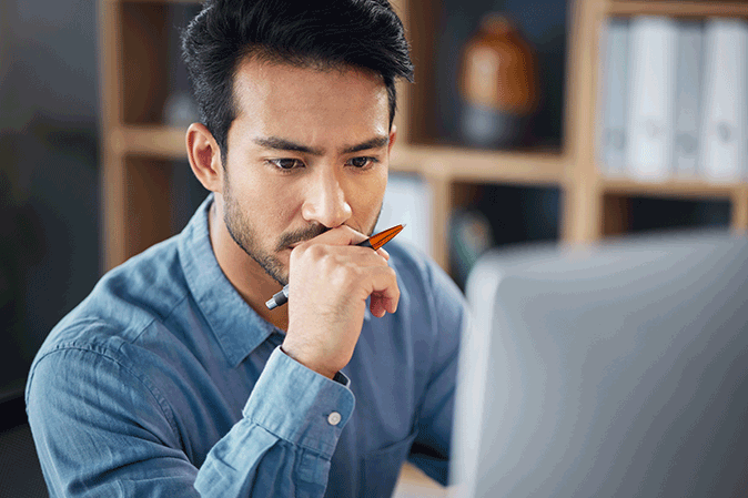 Young man looking intensely at computer screen