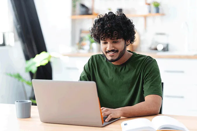 Young man typing on a laptop