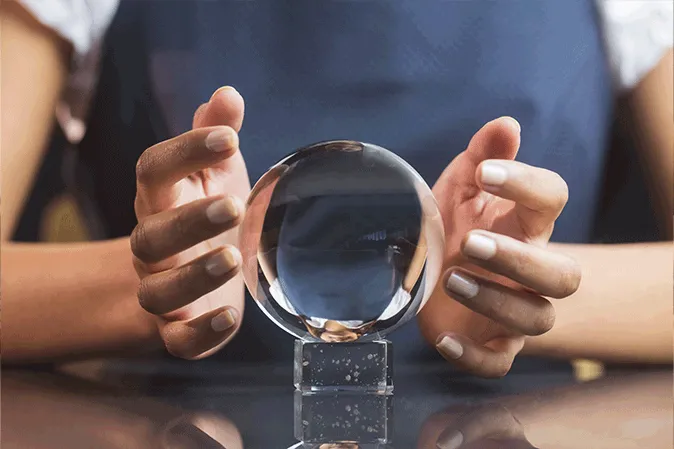 Young woman holding a crystal ball between her hands