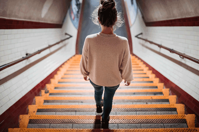 Young woman going down the stairs
