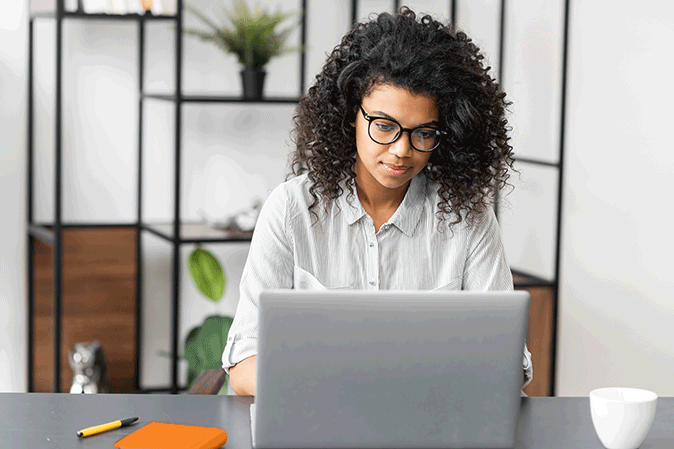 Young woman concentrating on laptop while typing