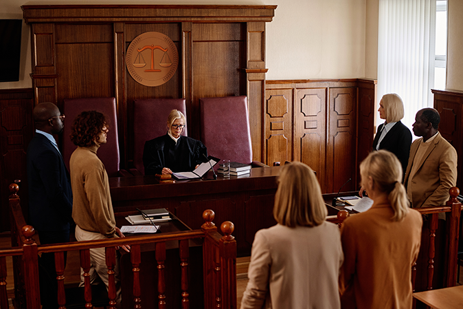 Courtroom with a judge, lawyers, plaintiff and defendant