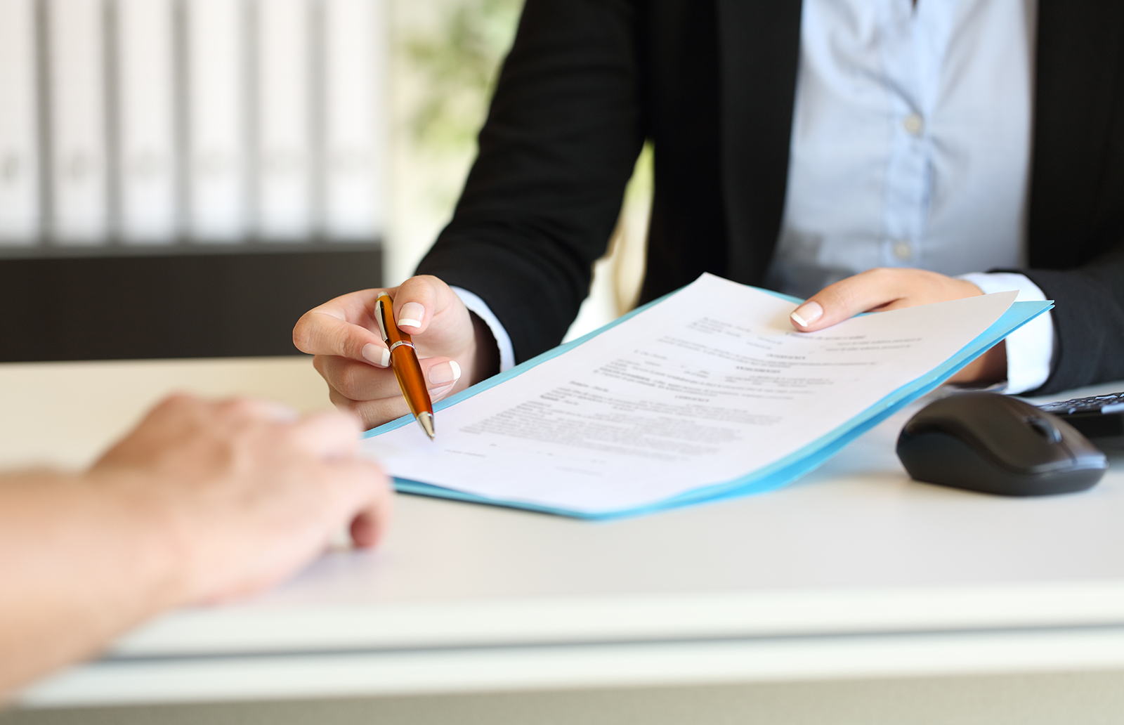 Lawyer working with a client to sign a contract