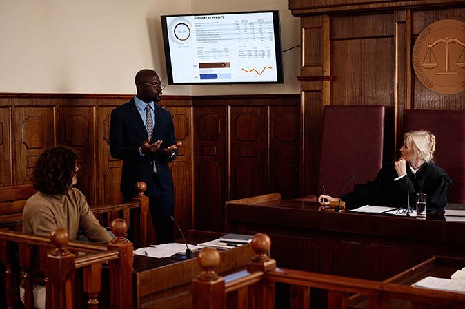 Lawyer going over a presentation in a courtroom in front of a judge