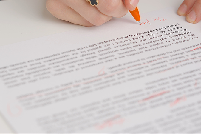 Professor marking up a student's essay