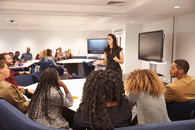 Female professor teaching to a class of students