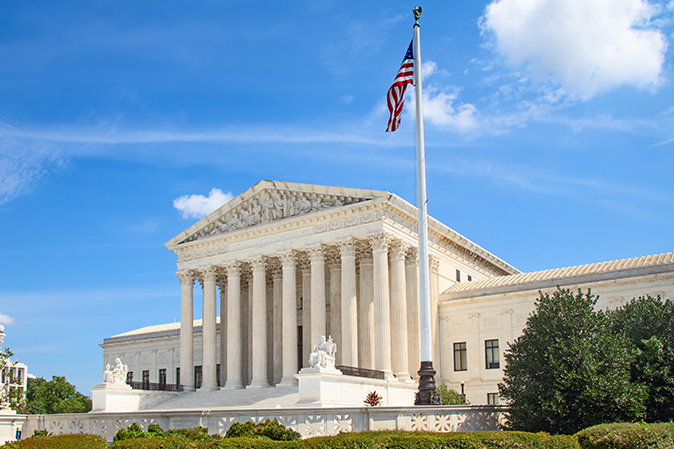 US Supreme Court building with the beautiful blue sky behind it