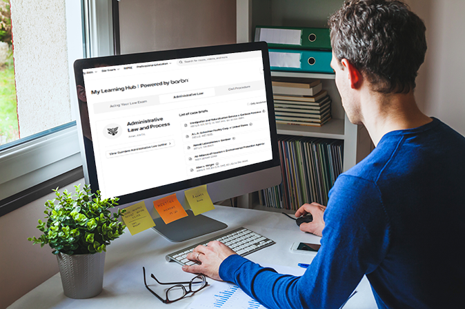 Young man sitting at a desk accessing My Learning Hub on his computer
