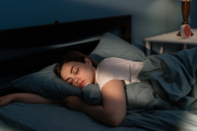 Young woman sleeping peacefully in their bedroom