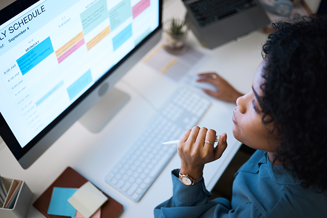 Young woman looking at her computer calendar