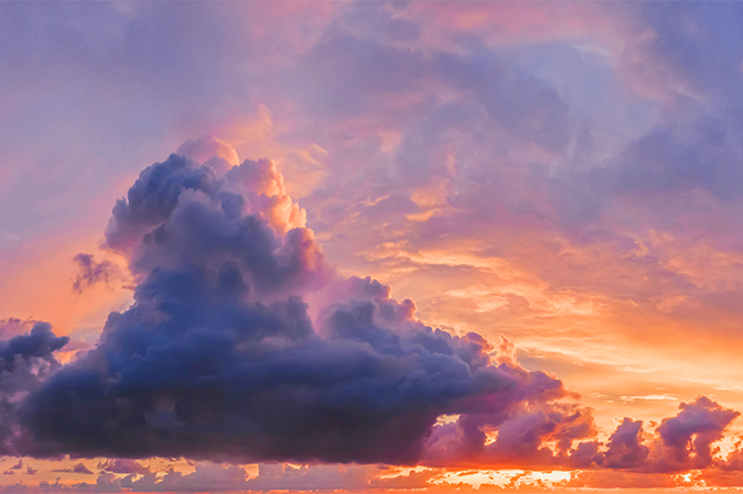 beautiful lilac clouds on the sky panorama and purple orange sunset.