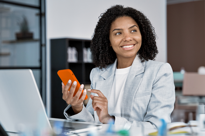 African American professional woman in office using mobile phone