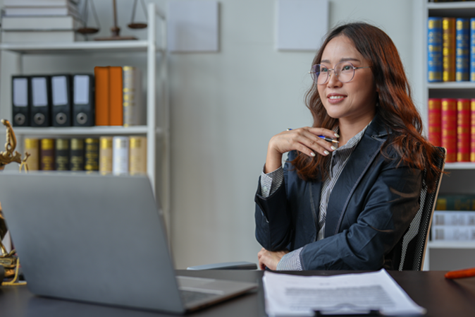 Professional legal woman sitting at desk in office