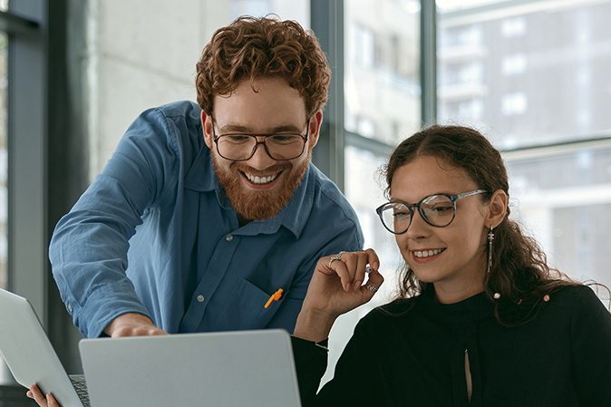 Two work colleagues looking at laptop