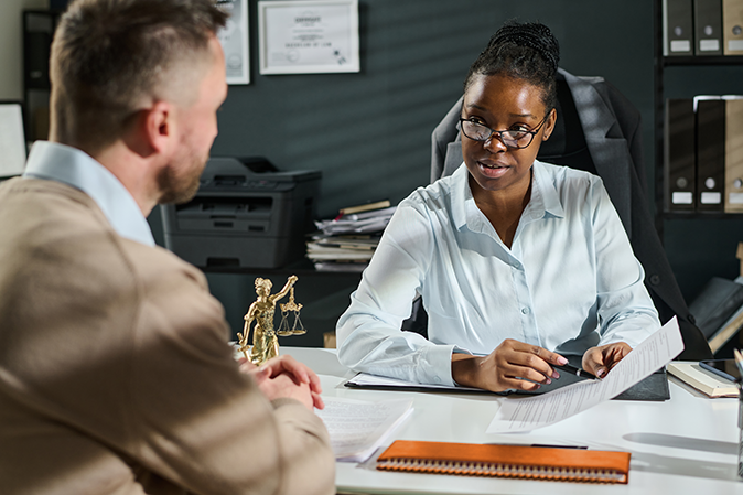 Young woman going over paperwork in the office with a client