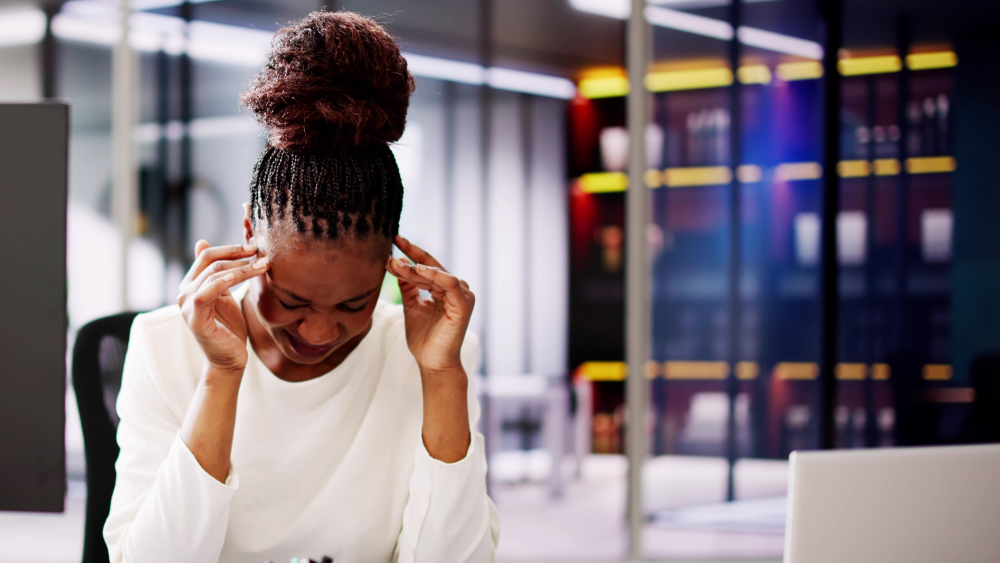 A distressed female lawyer with her head in her hands
