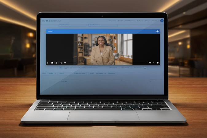 Laptop sitting on a desk with a Skills Scenario video on the screen