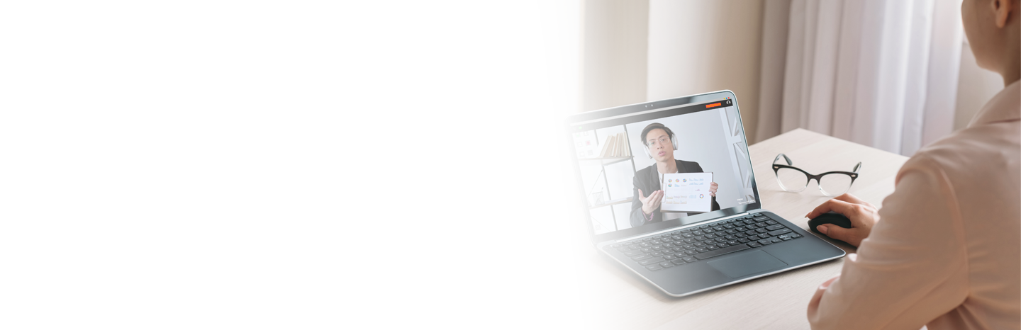 Young woman watching a man presenting on laptop