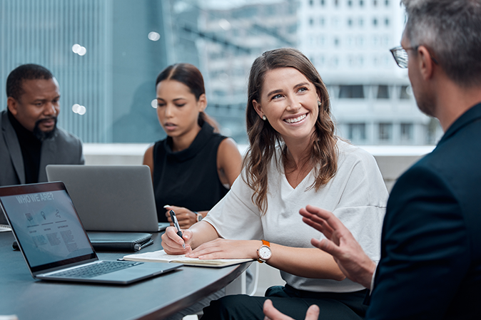 Young woman working with coworker in the office