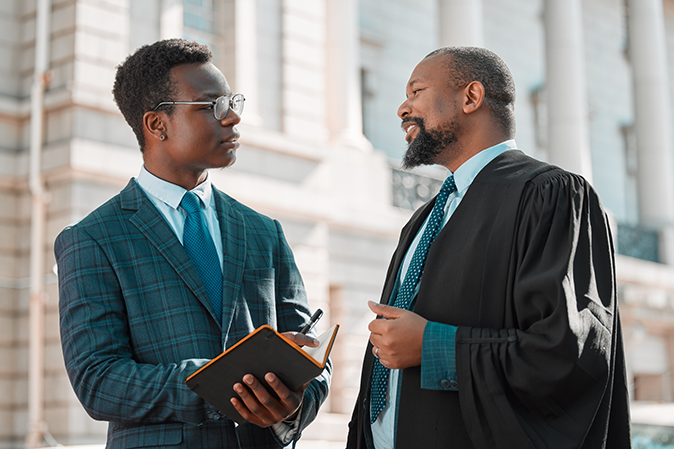 two male lawyers talking in the city.