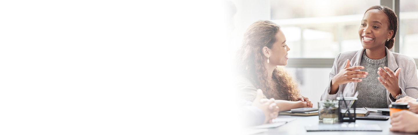 Young woman talking to her coworkers in a meeting