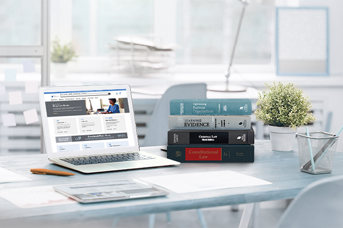 Westacademic books and laptop on a desk
