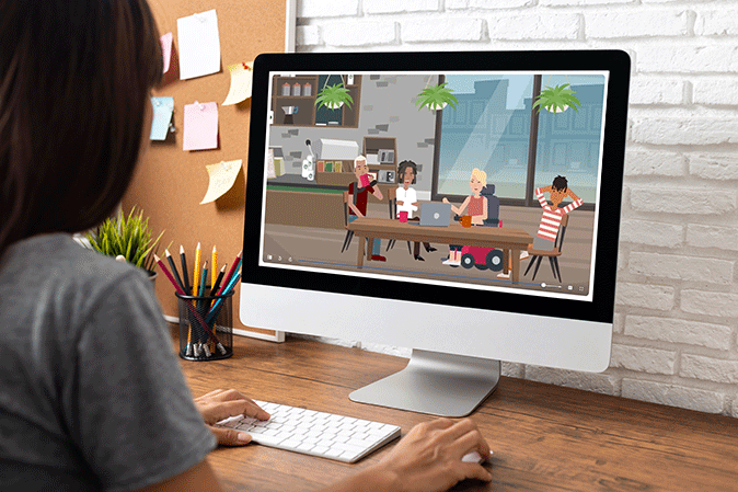 Woman sitting at her desk watching a Foundations episode on her computer