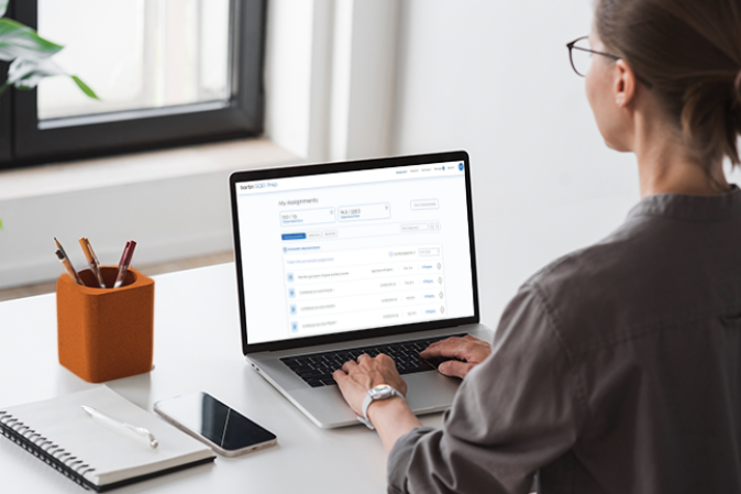 Woman sitting at a desk on a laptop using the SQE1 Prep Demo